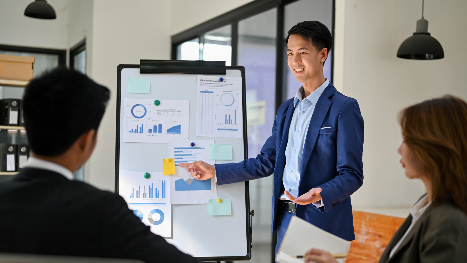 An Asian entrepreneur gives a presentation to his colleagues.