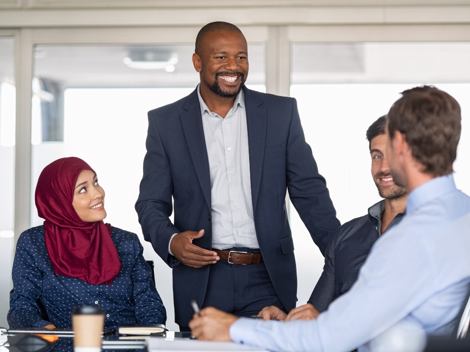 A man in a business suit discussing with his colleagues, Information Systems researchers.