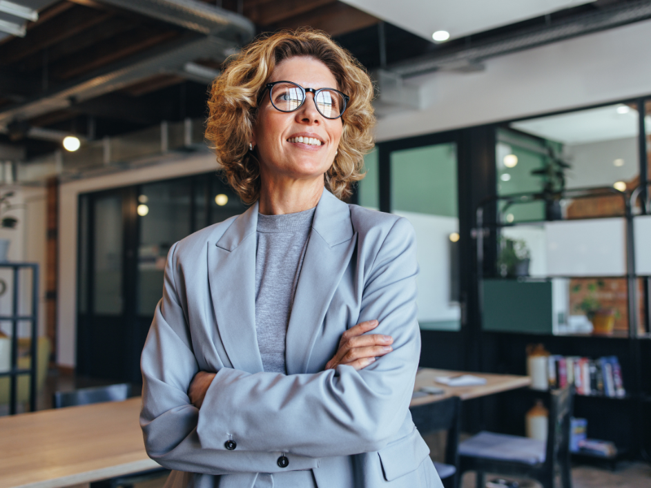 Strategic Management researcher, a woman in glasses standing in an office.