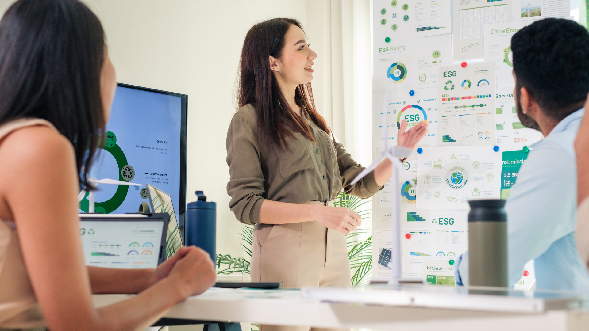 A woman presenting to colleagues on sustainability in business.