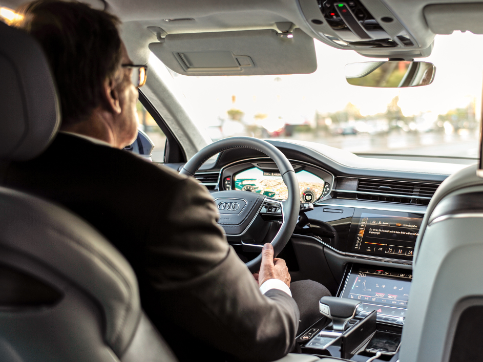 An older male driving an Uber, attentively navigating the road.