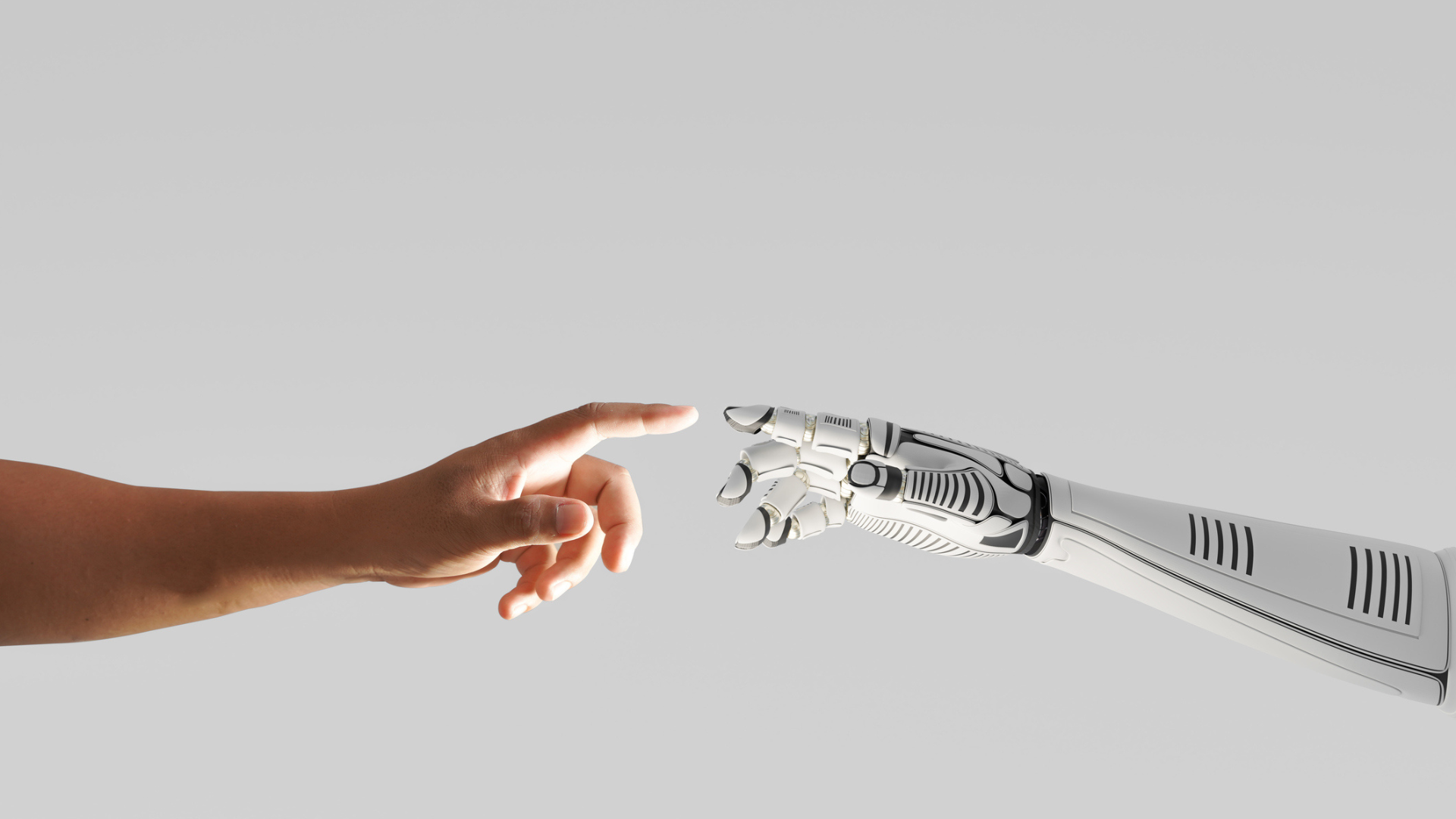 A human hand and robot hand reach toward each other.