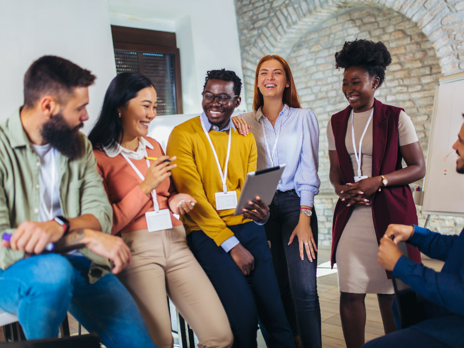 A group of diverse researchers, of various races and ages, smiling.