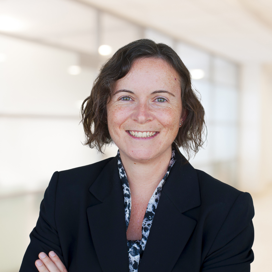 Headshot of Trish Ruebottom, a smiling woman wearing a black blazer.