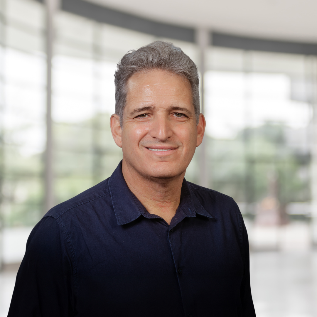 Headshot of Yair Berson, a smiling man with gray hair and a blue shirt.