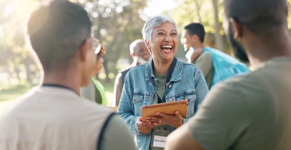 woman smiling holding a clip board