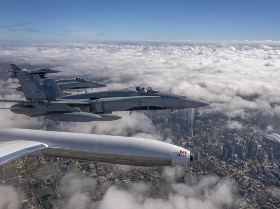 U.S. F-16 and Canadian CF-18 fighter jets supporting the North American Aerospace Defense Command flying over Toronto.